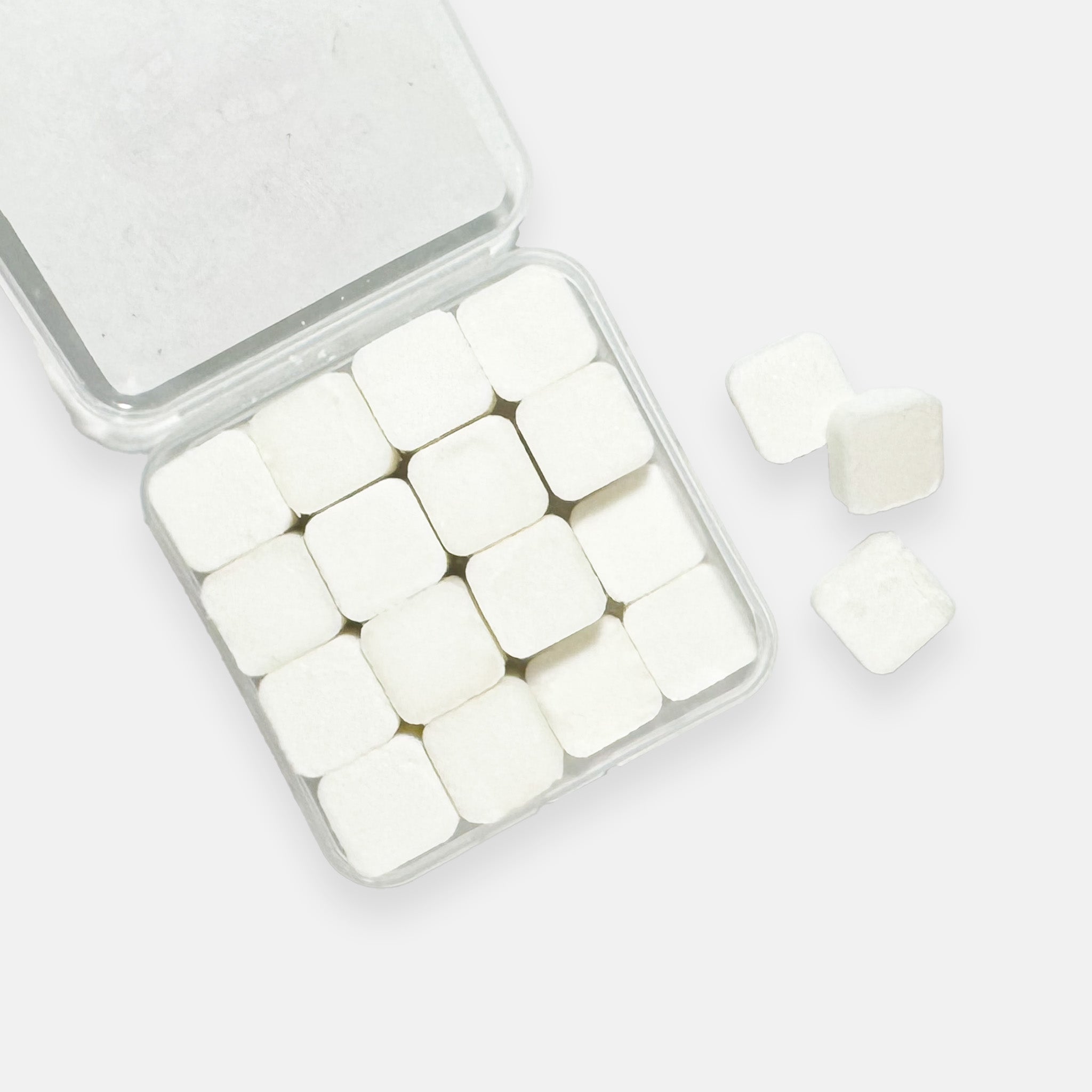 An open pack of Droolrz candy with three pieces out and displayed on the side all on a plain grey background